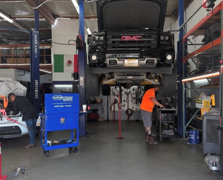 PowertrainWorx shop with vehicle on lift